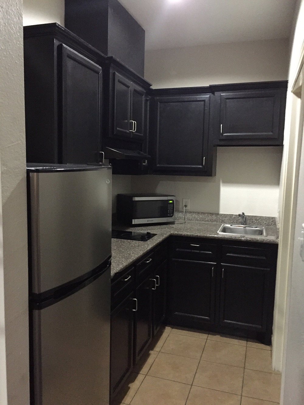 Kitchenette with refrigerator, microwave and sink