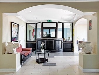 Front desk and lobby seating area at Crystal Inn Houston